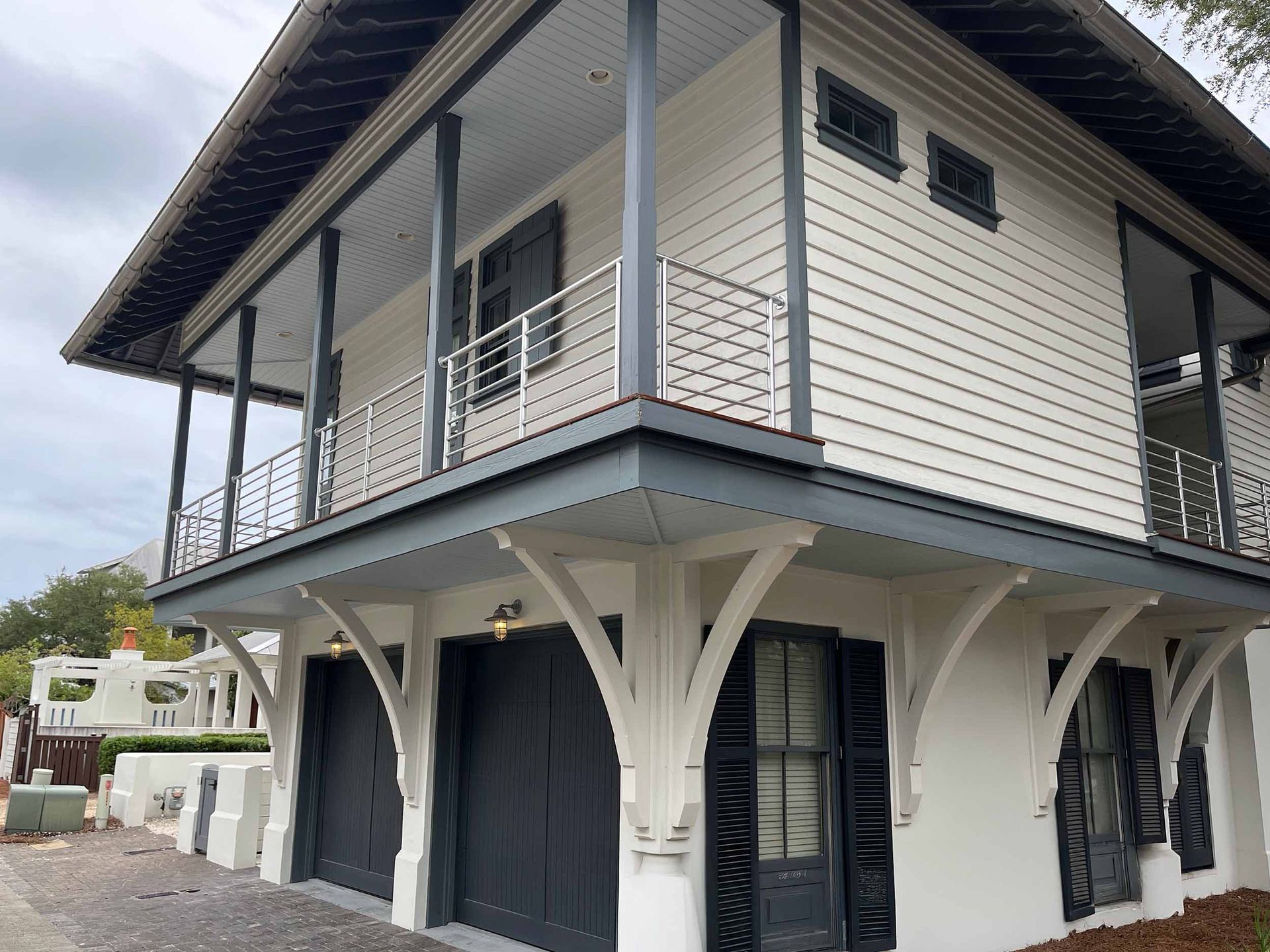 Modern white two-story house in Catalina Foothills with metal-railed balcony