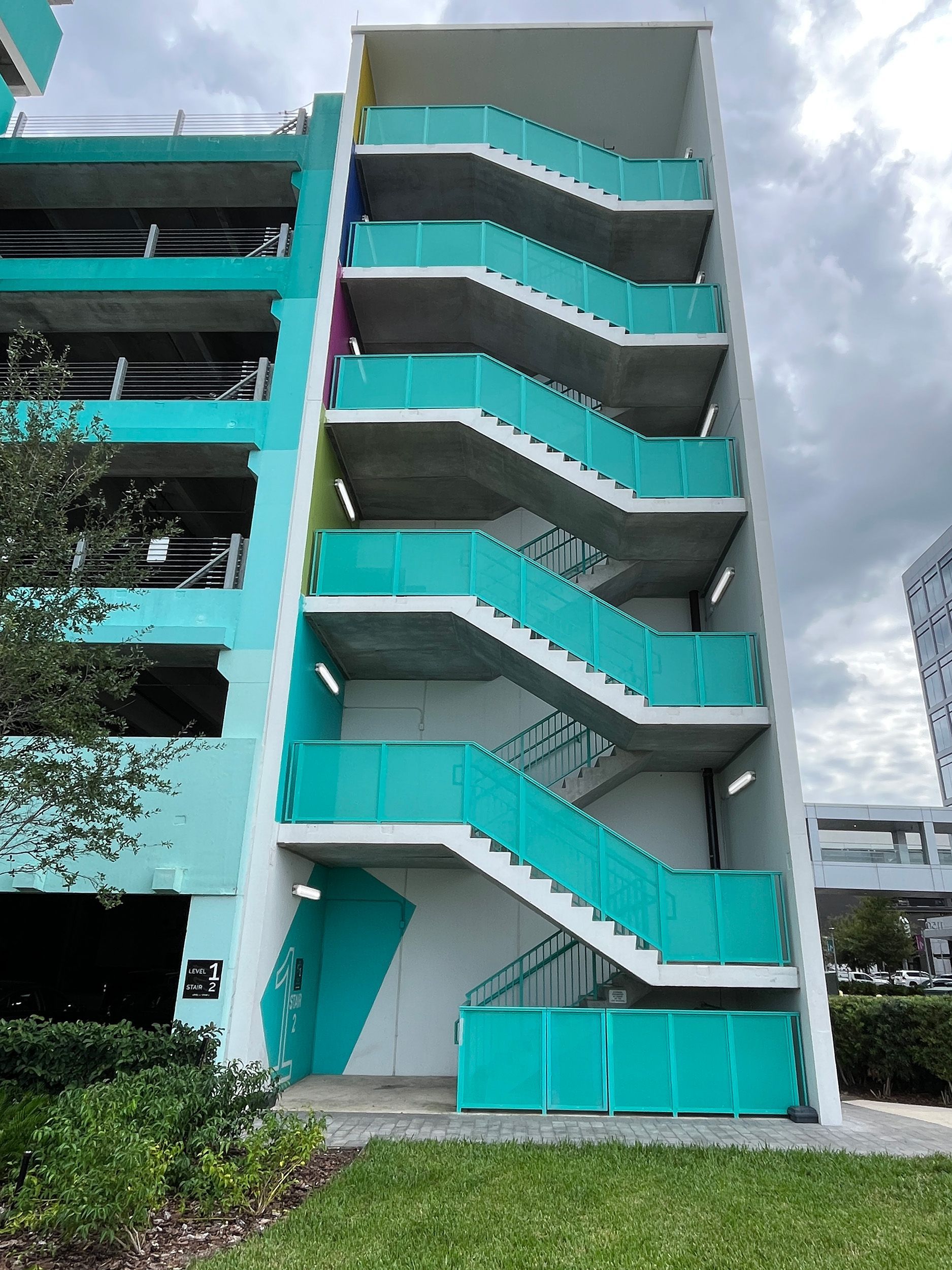Turquoise building exterior with blue stairway and railings