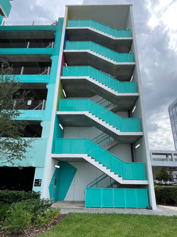 Turquoise building exterior with blue stairway and railings