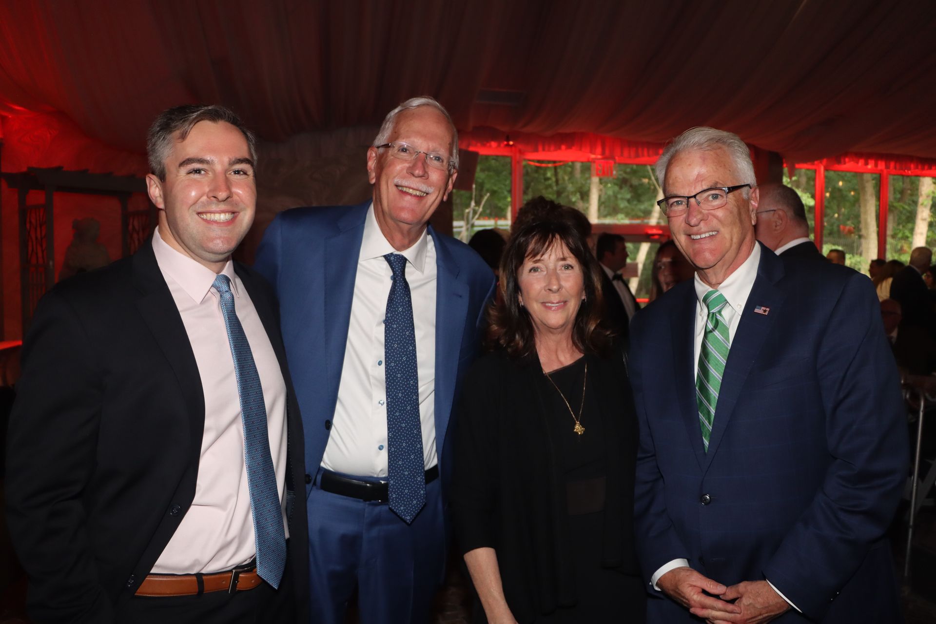 A group of people in suits and ties are posing for a picture.