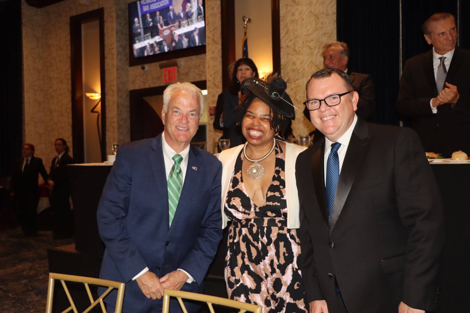 Two men and a woman are posing for a picture together