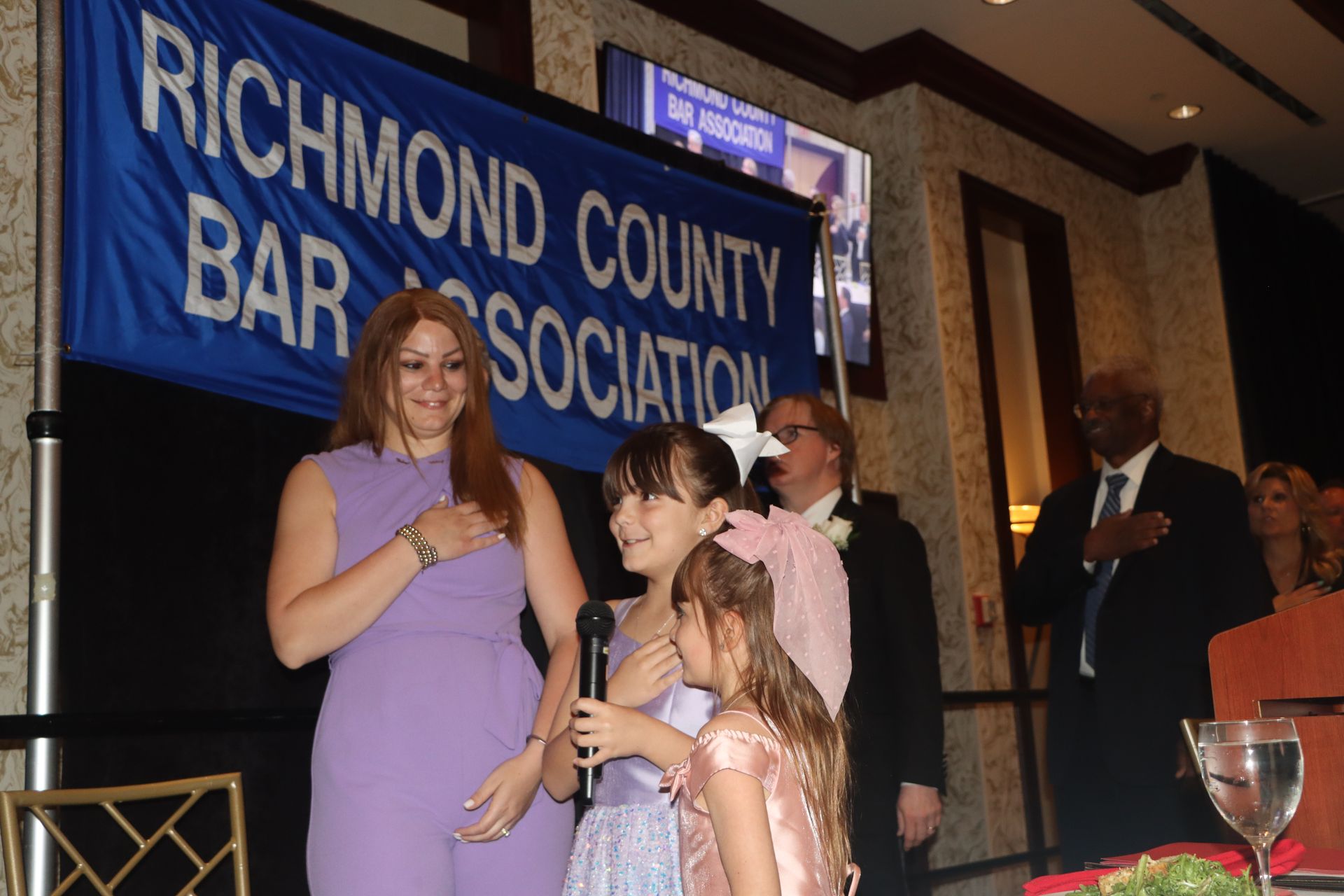 A group of people standing in front of a sign that says Richmond County bar association