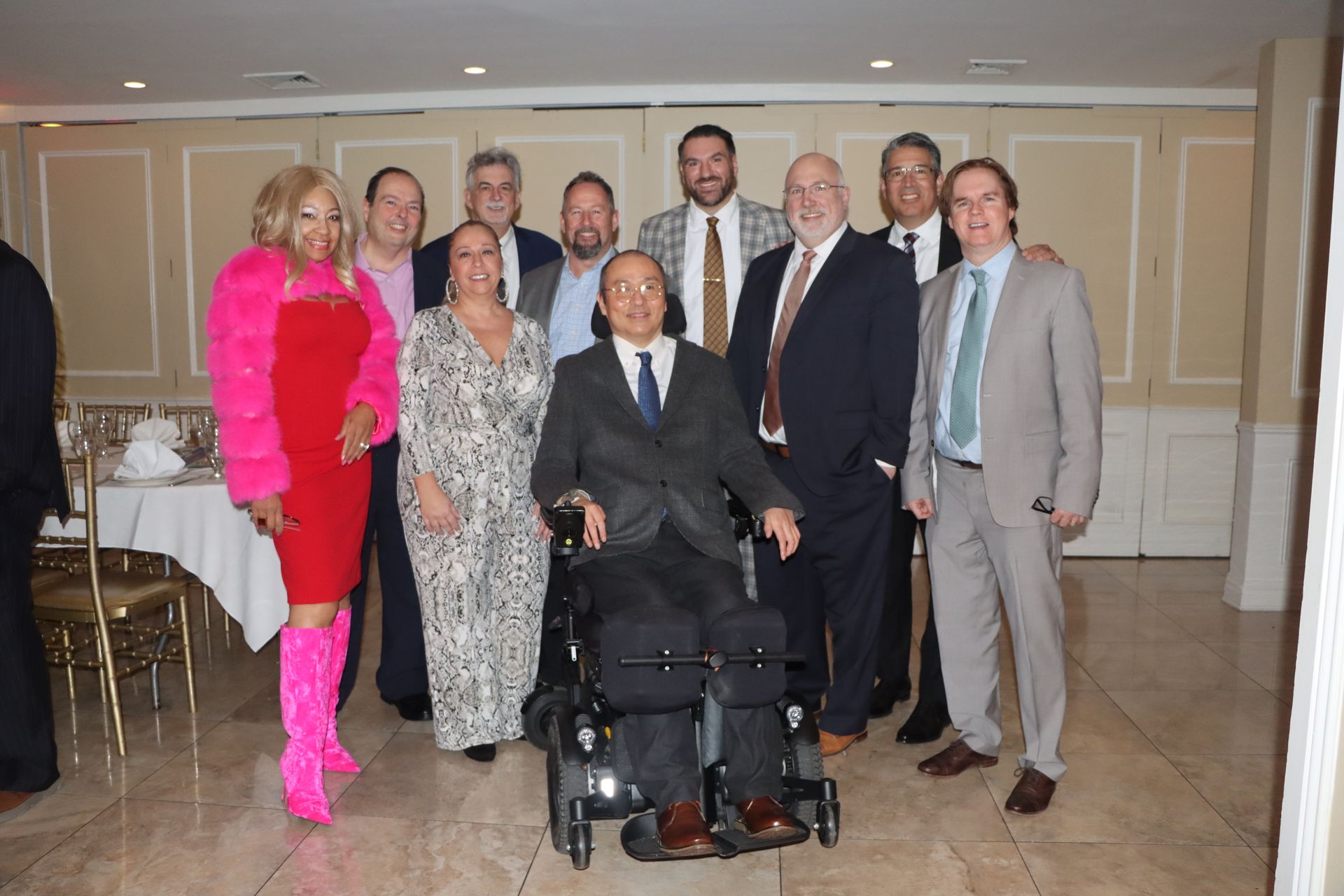 A Group Of People Posing For A Picture With A Man In A Wheelchair — Staten Island, NY — RCBA
