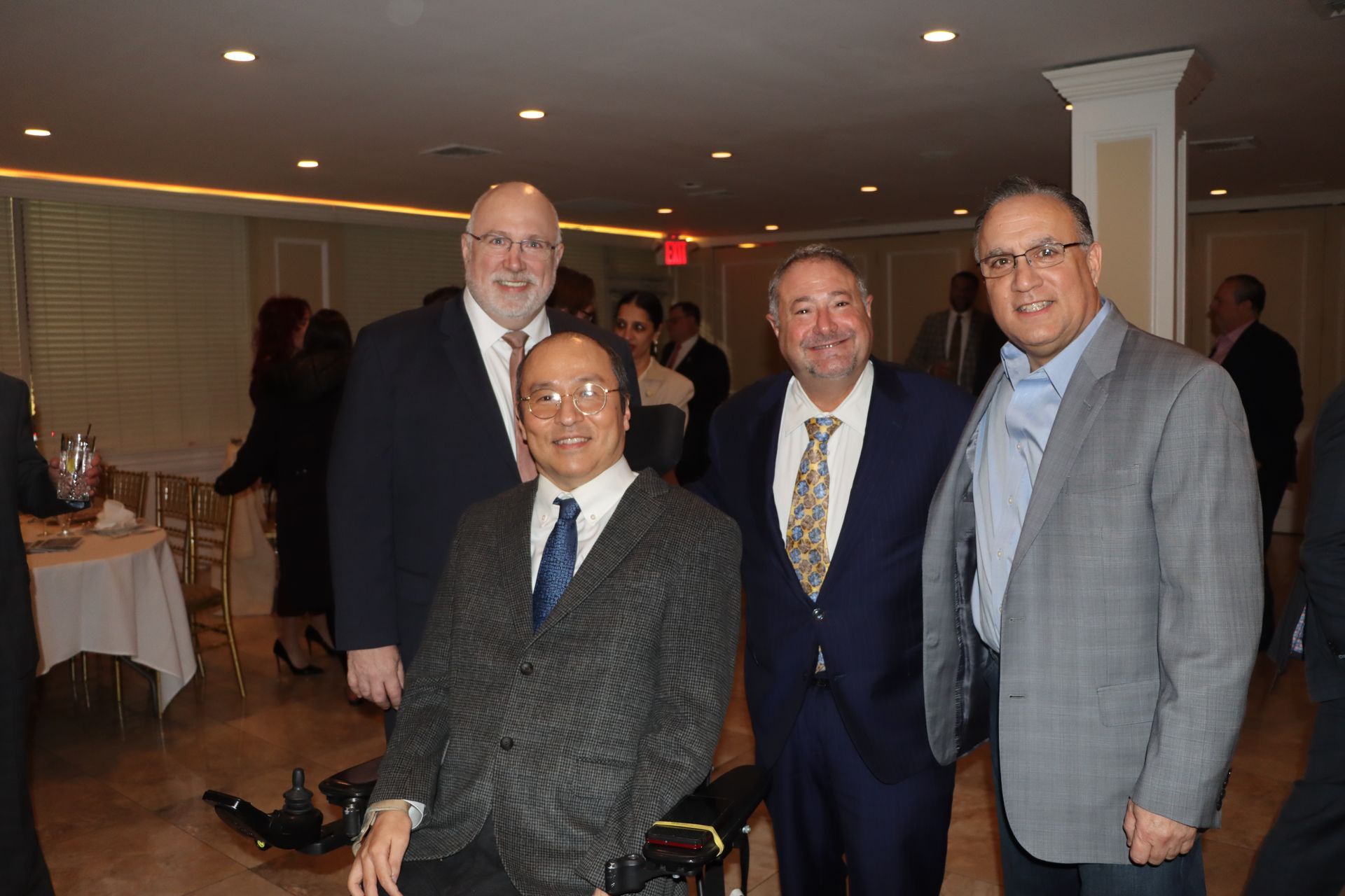 One Man Is In A Wheelchair While A Group Of Men Pose For A Photo — Staten Island, NY — RCBA