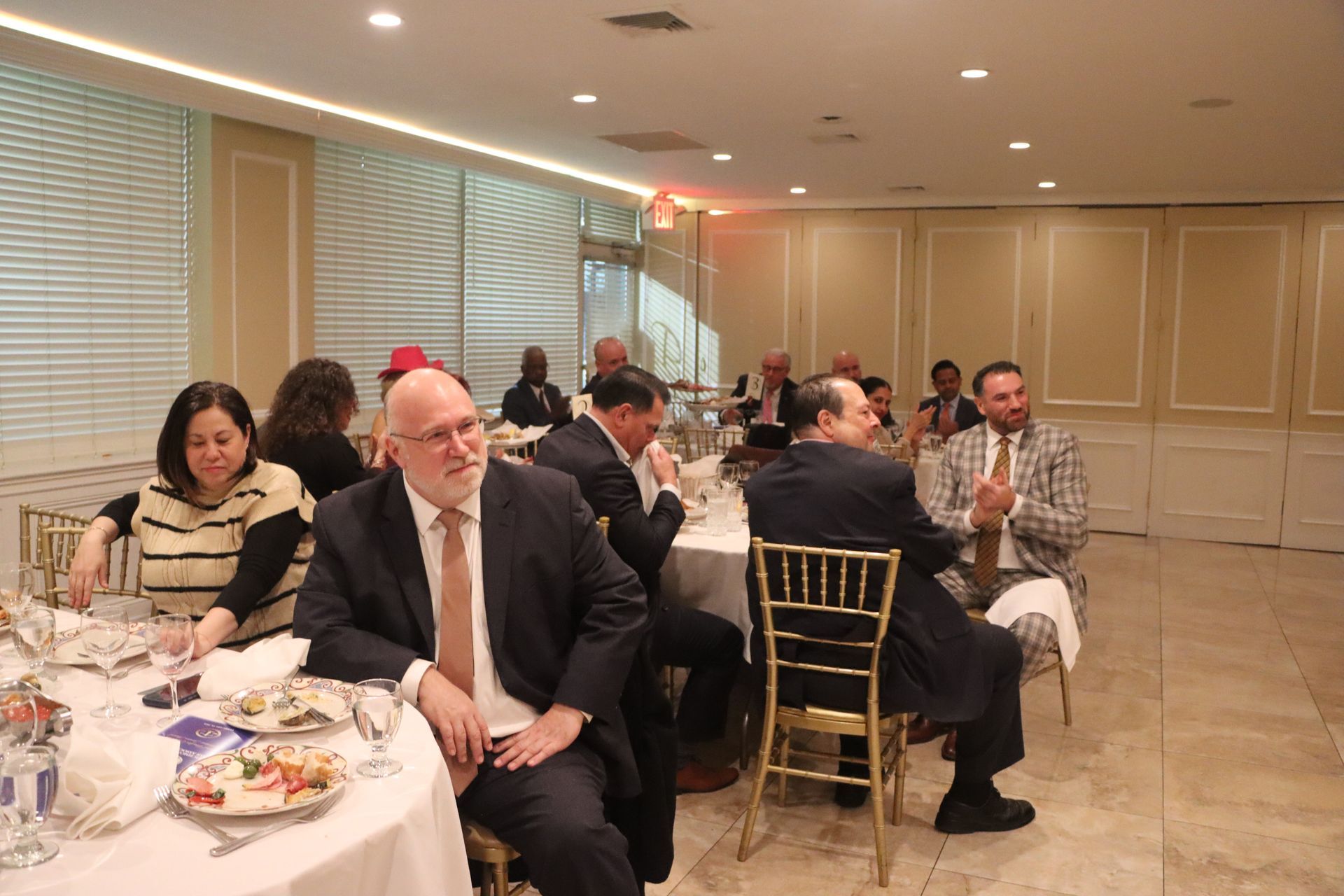 A Room Has A Number Of Individuals Seated At Tables — Staten Island, NY — RCBA