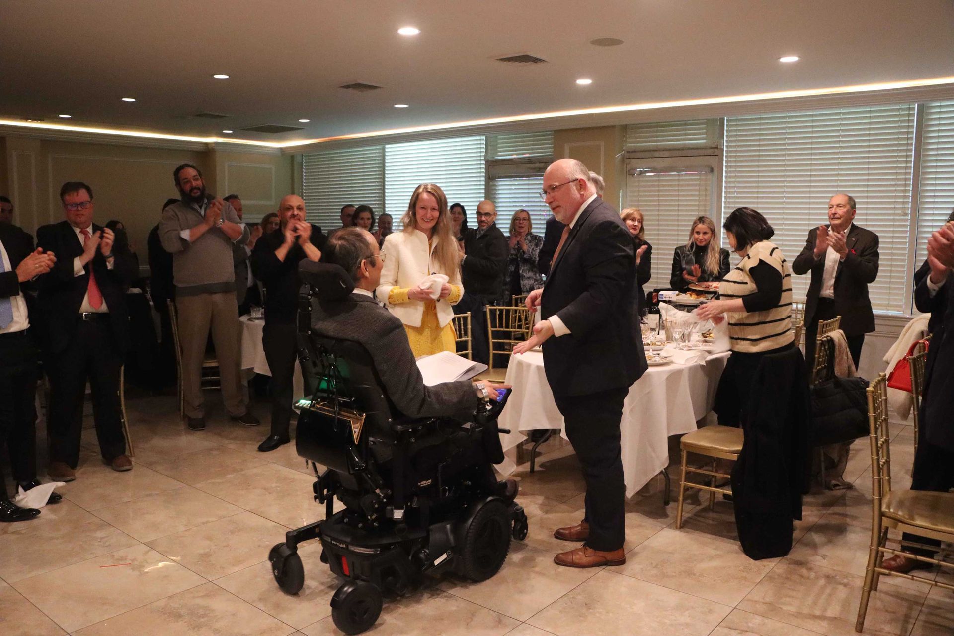 Crowd Speaking To The Man in The Wheelchair — Staten Island, NY — RCBA