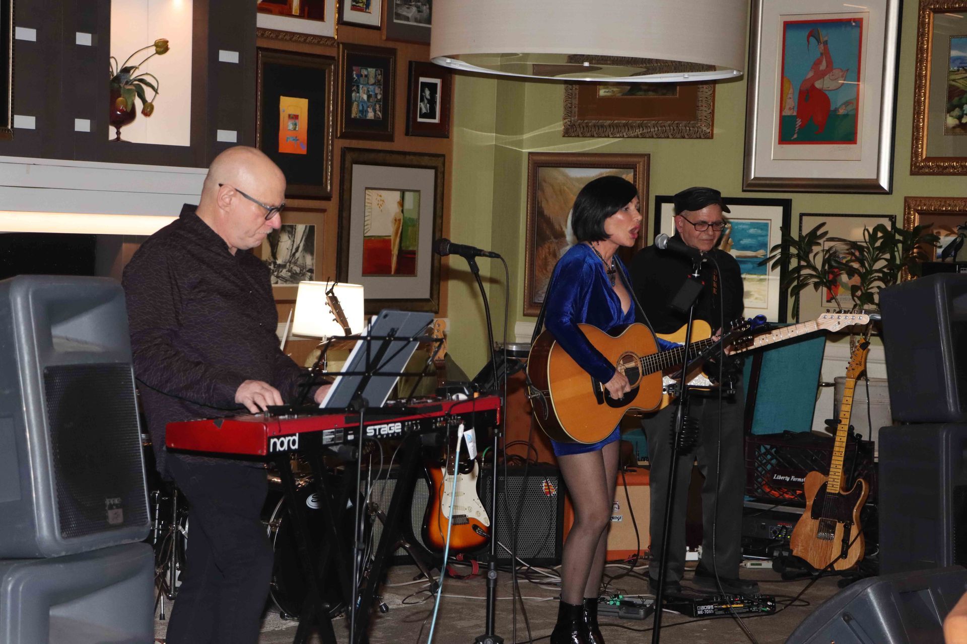 A Woman Is Playing A Guitar And A Man Is Playing A Keyboard | Staten Island, NY | RCBA