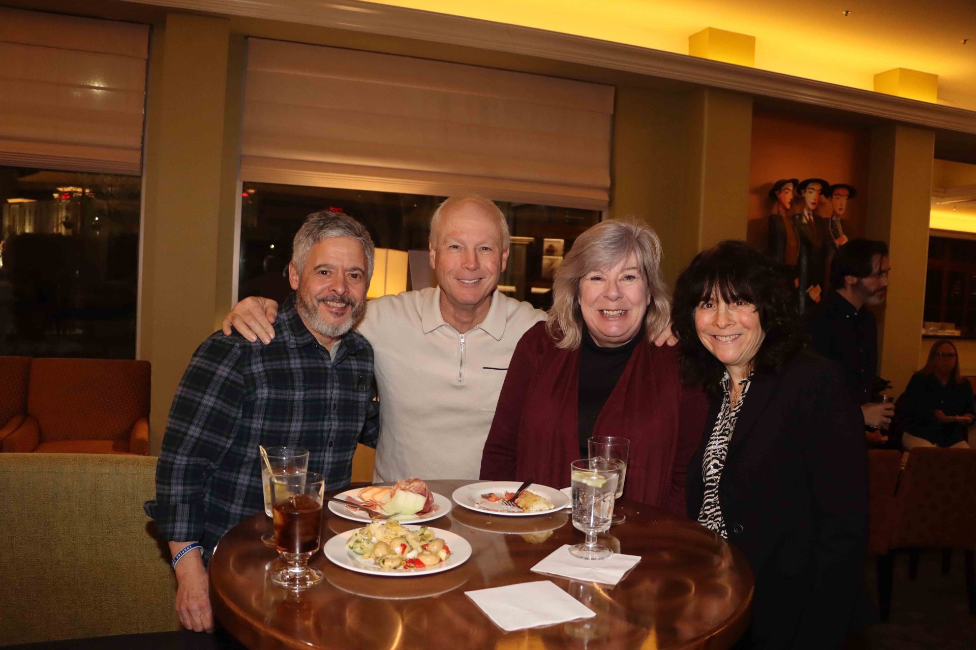 A Group Of People Are Posing For A Picture While Sitting At A Table With Plates Of Food | Staten Island, NY | RCBA