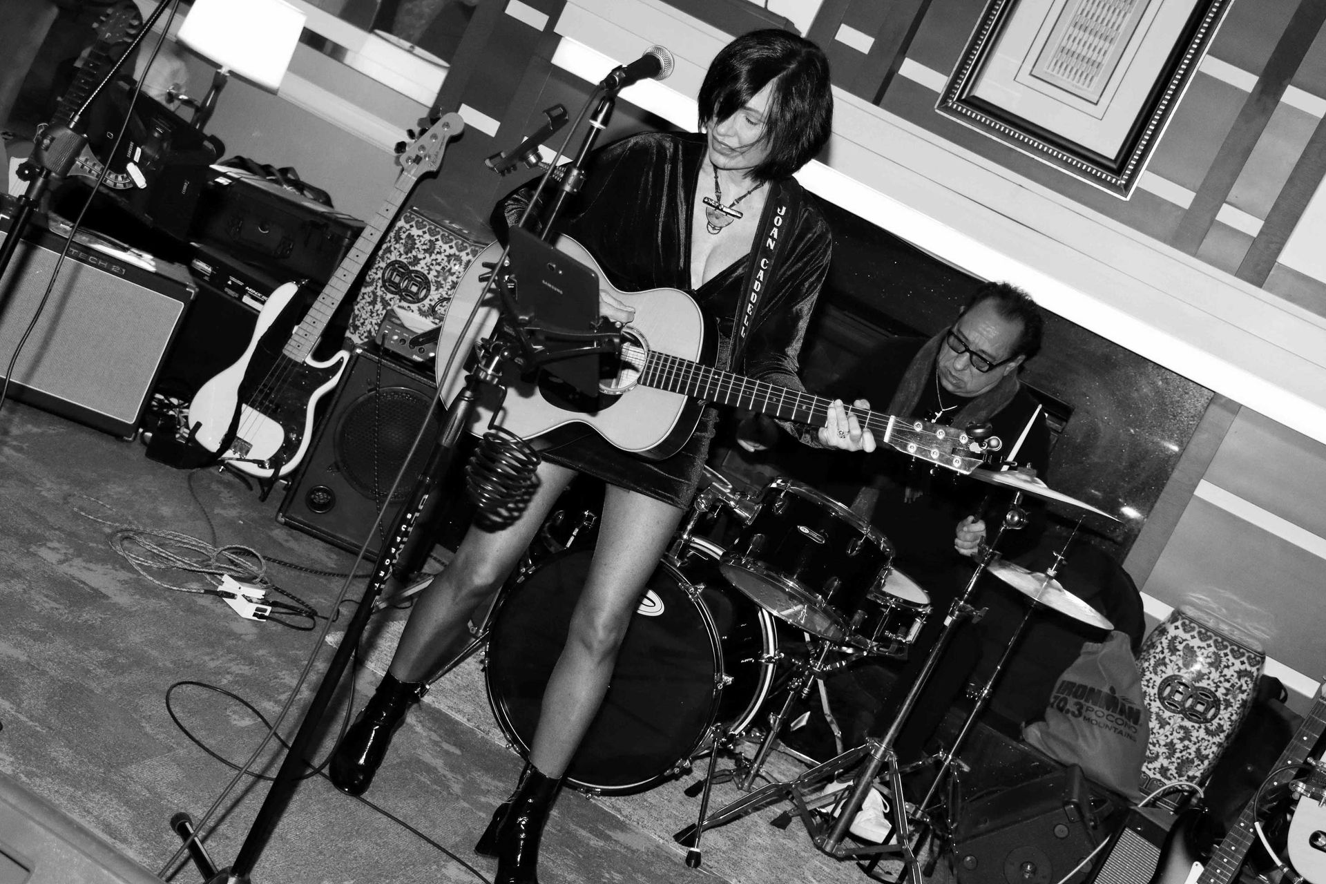 A Woman Is Singing Into A Microphone While Playing A Guitar | Staten Island, NY | RCBA