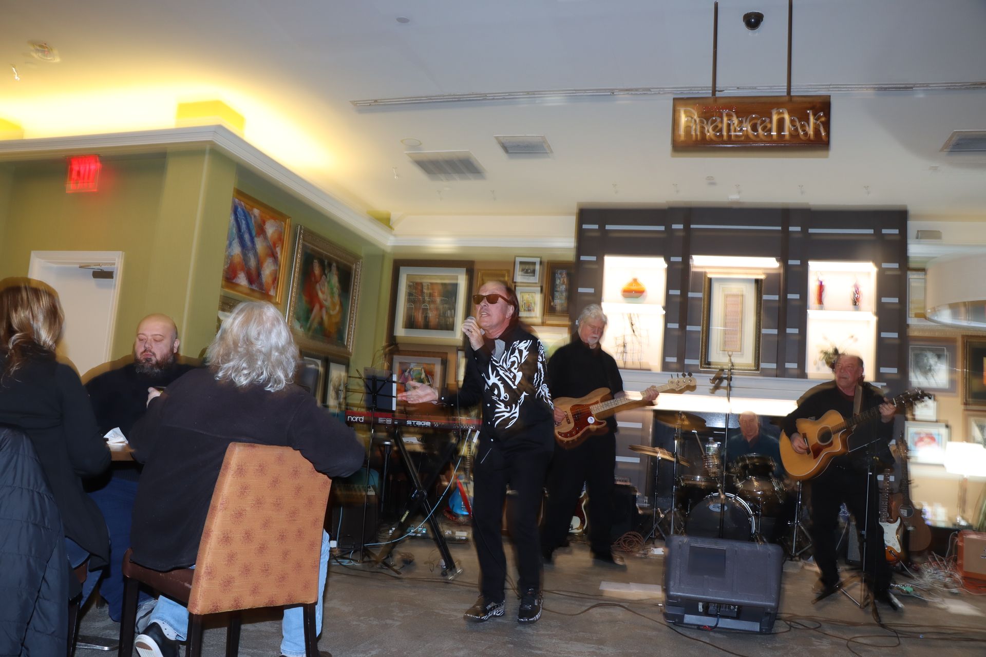 A Group of People are Sitting at Tables in Front of a Sign that says Bienvenue — Staten Island, NY — RICHMOND COUNTY BAR ASSOCIATION