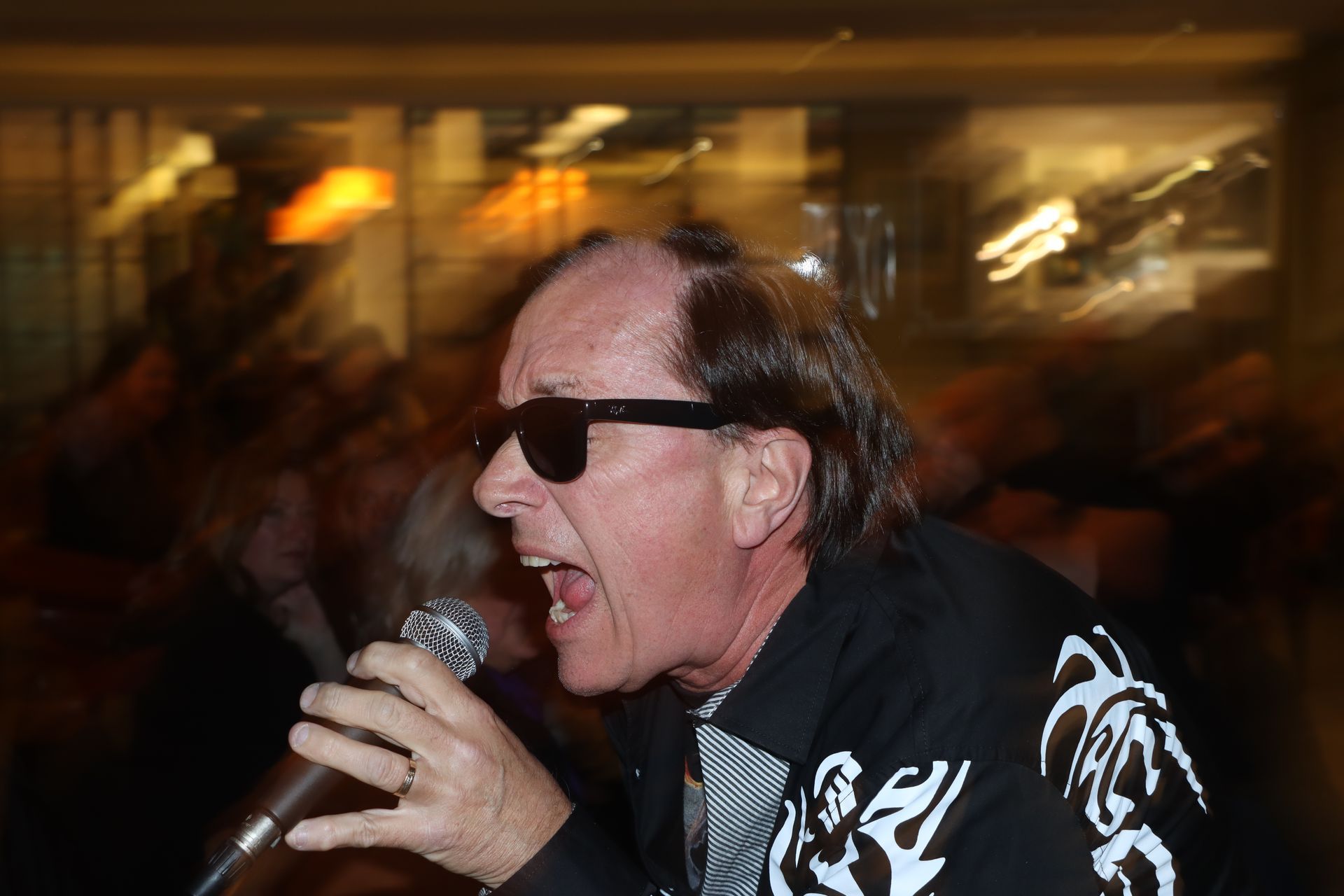 A Man Wearing Sunglasses is Singing into a Microphone — Staten Island, NY — RICHMOND COUNTY BAR ASSOCIATION