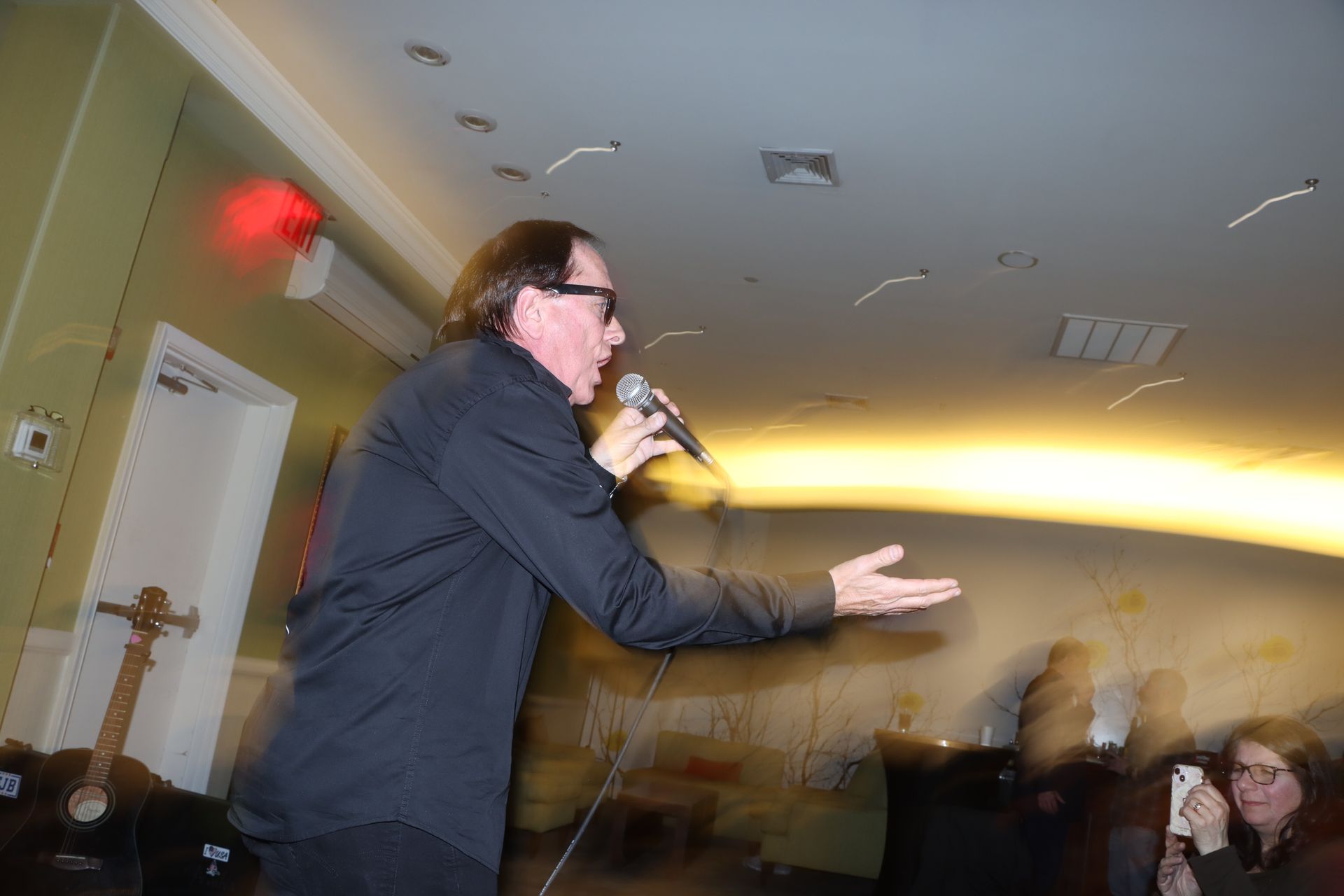 A Man is Singing into a Microphone in Front of a Crowd — Staten Island, NY — RICHMOND COUNTY BAR ASSOCIATION