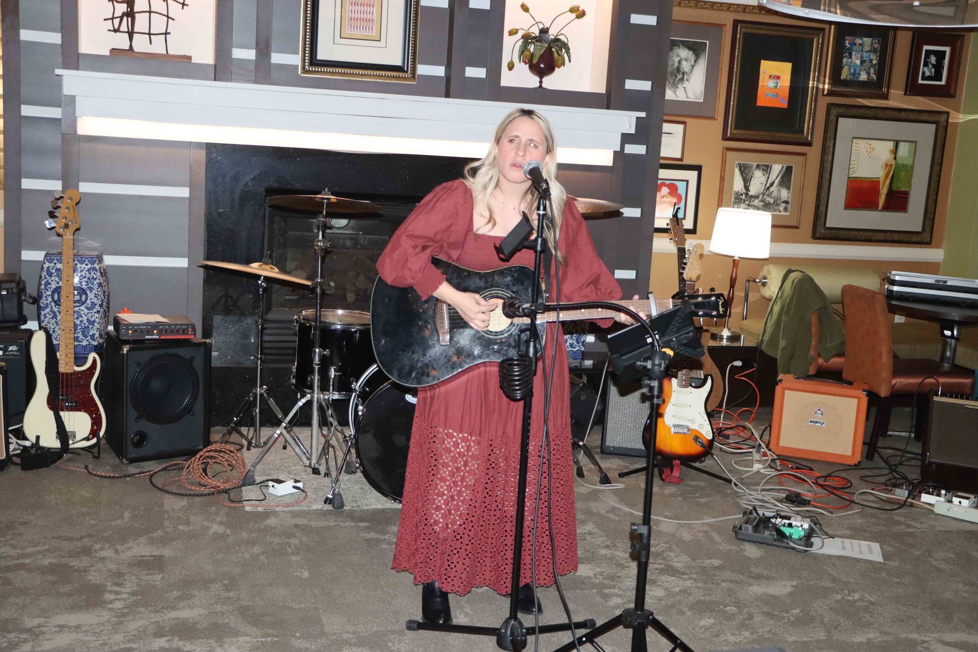 A Woman Singing Into A Microphone While Playing A Guitar | Staten Island, NY | RCBA