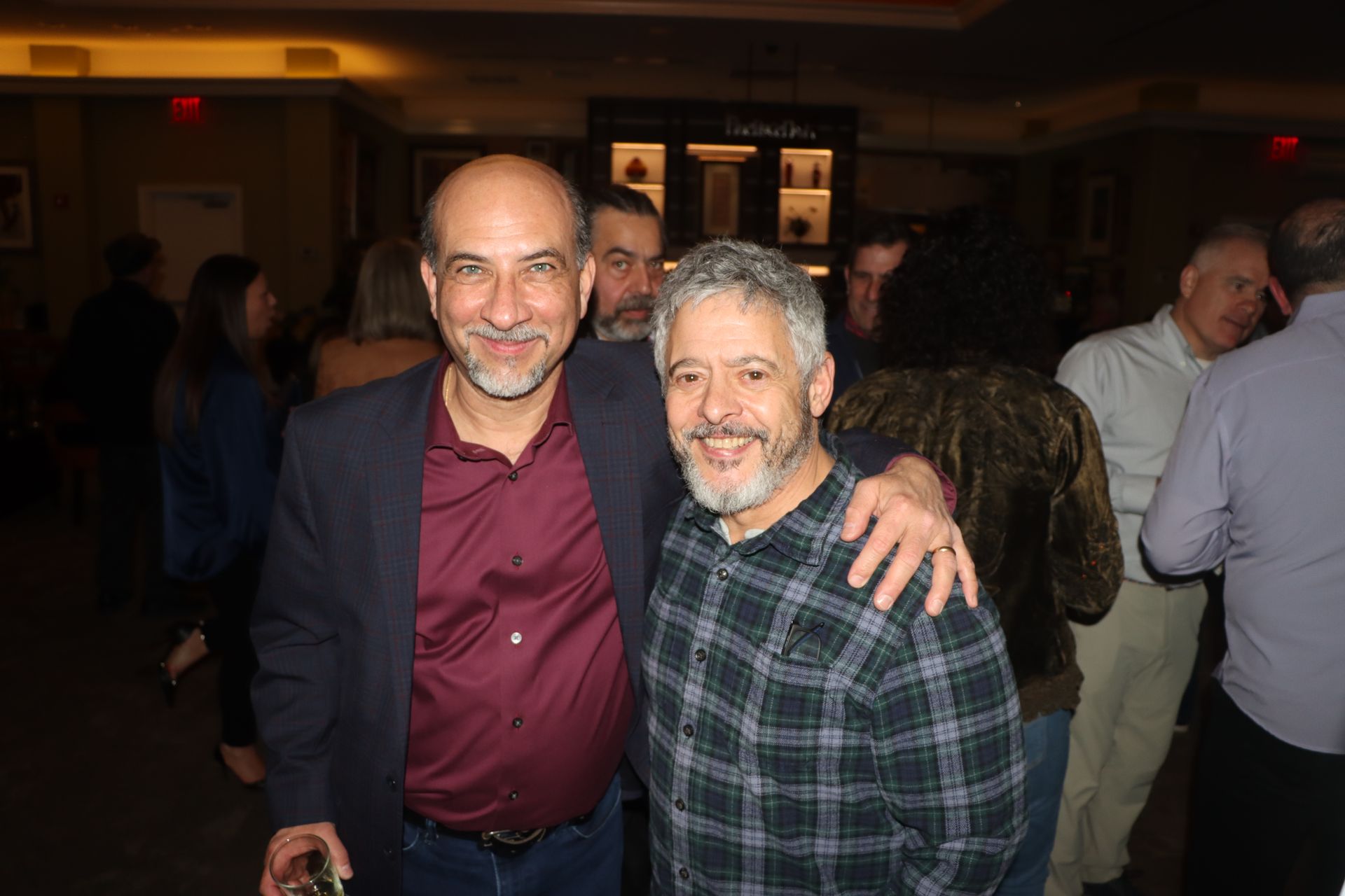 Two Men Are Posing For A Picture Together In A Crowded Room | Staten Island, NY | RCBA