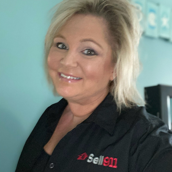 A woman wearing a black shirt that says sell 911