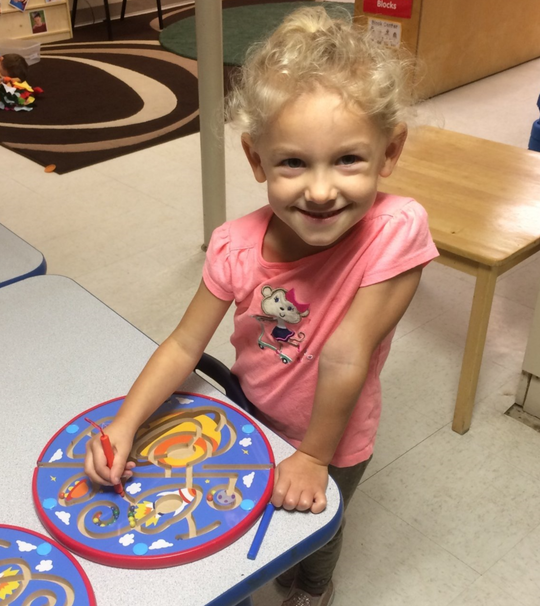 Child smiling  - child learning center in Moline IL
