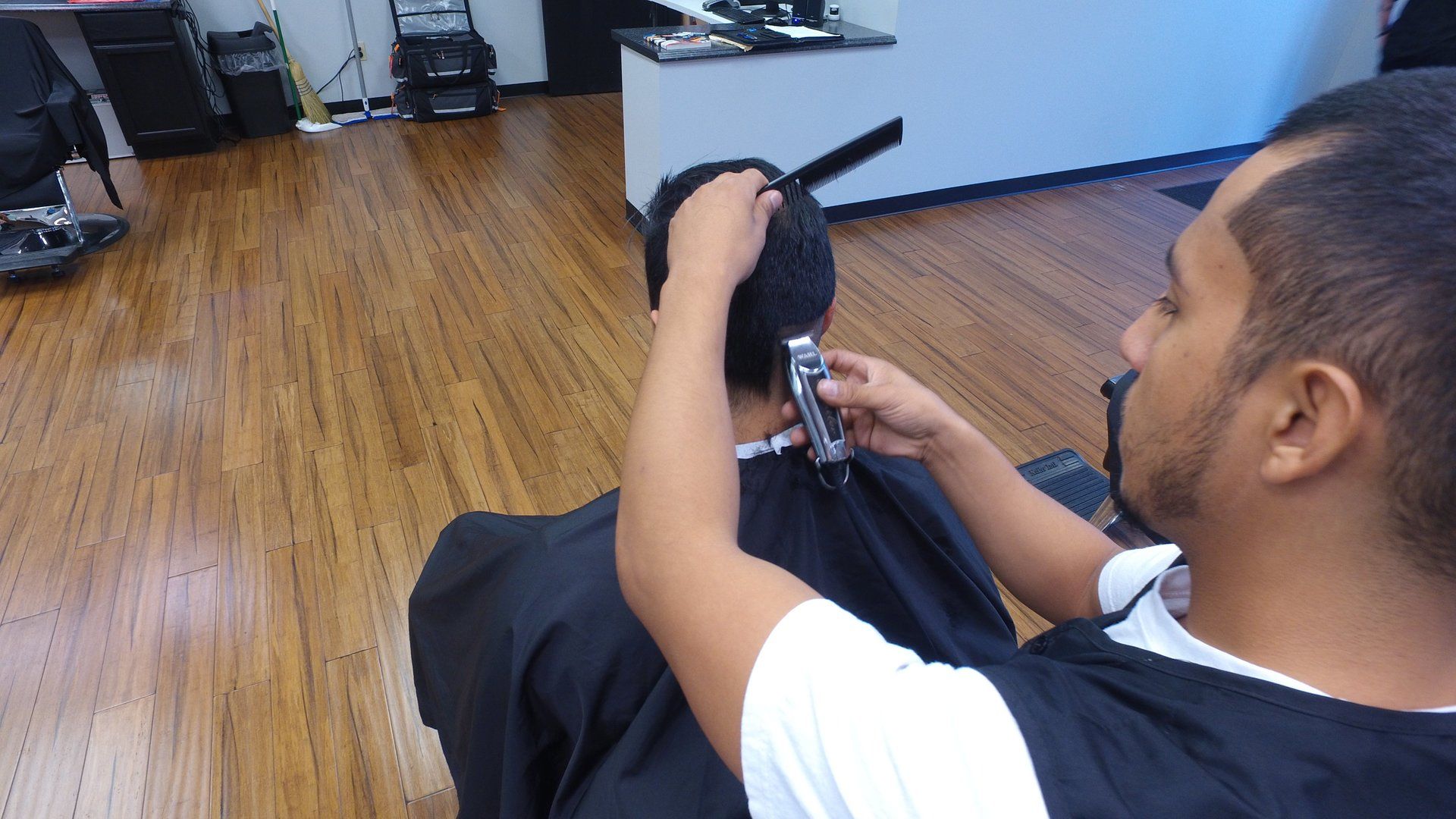 A man is getting his hair cut by a barber