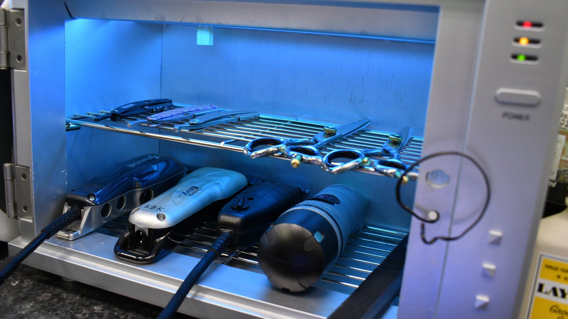 A bunch of remotes are sitting inside of a uv sterilizer