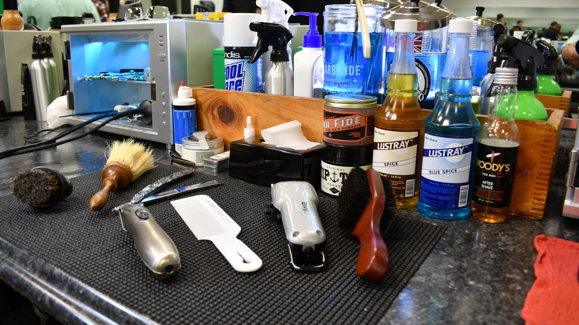 A table with a lot of bottles and brushes on it