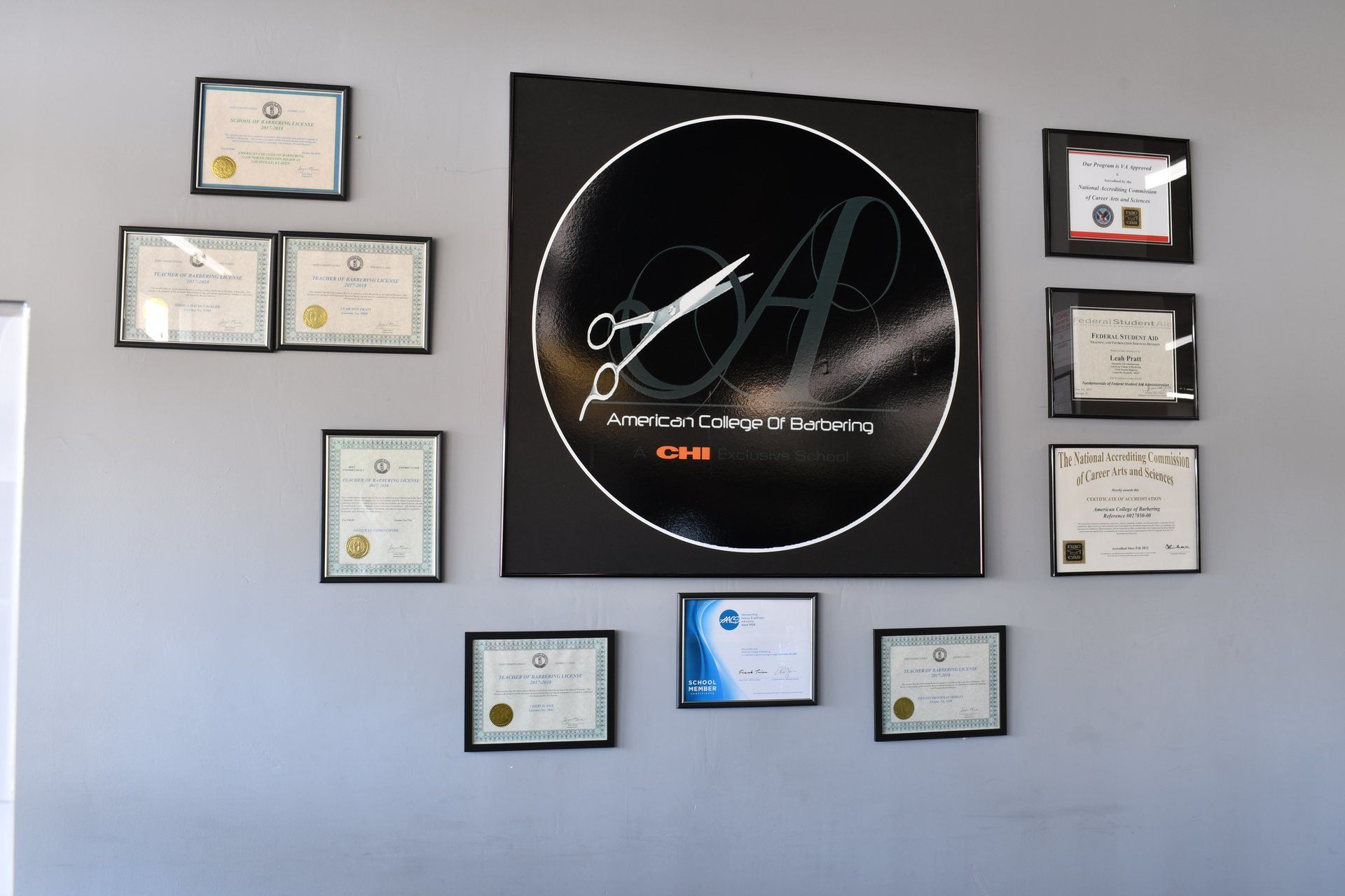 A wall with a lot of certificates on it