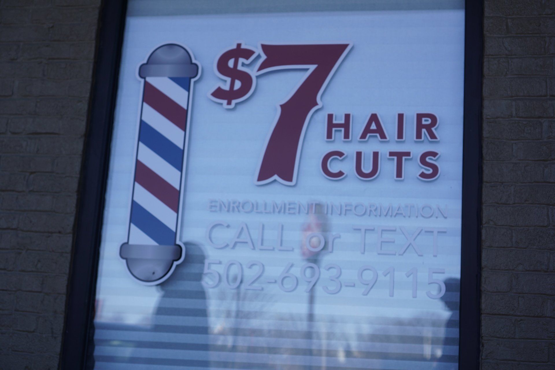 A sign that says $ 7 hair cuts on it