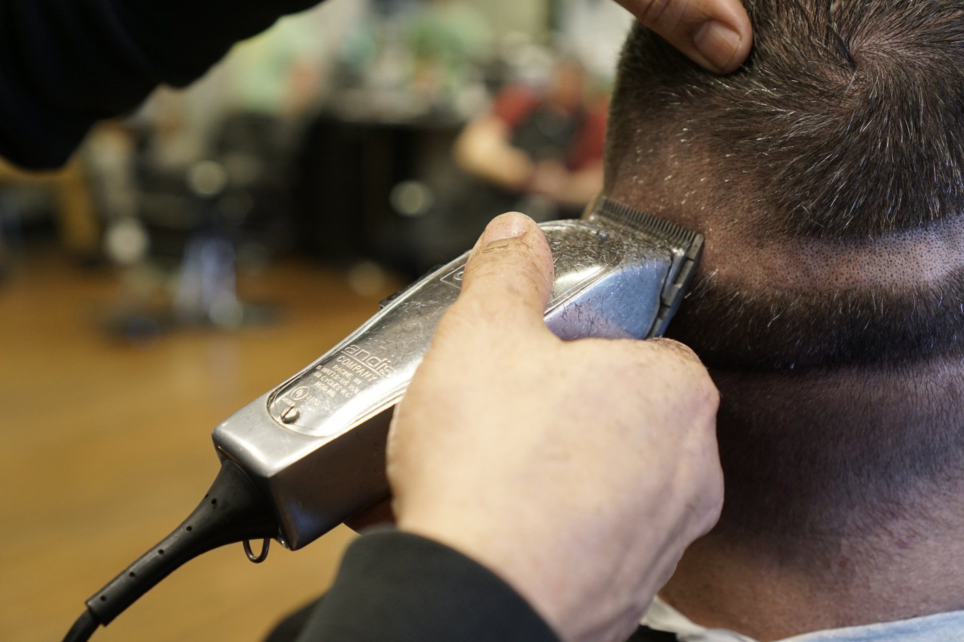 A man is getting his hair cut by a barber
