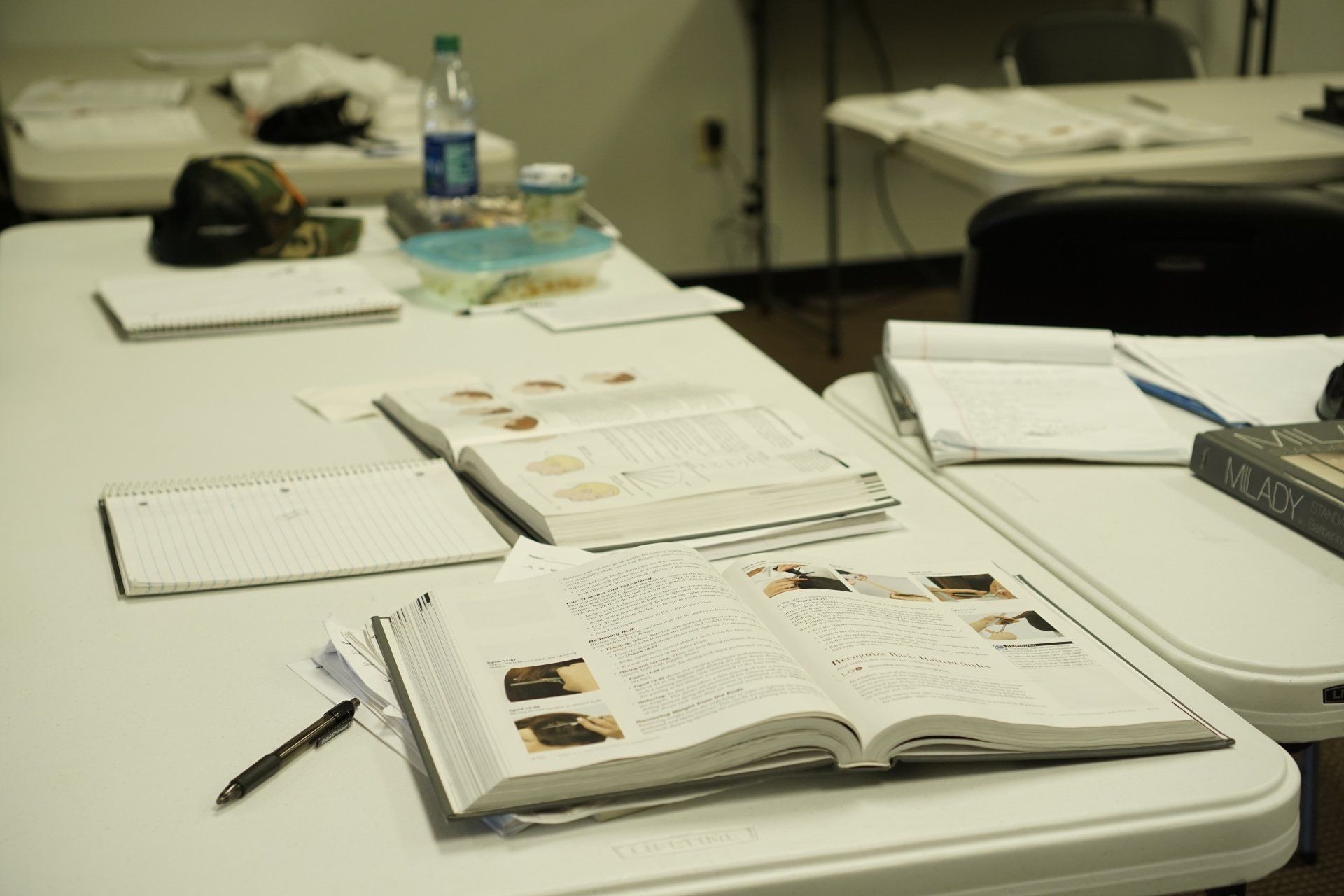 A book is open on a table in a classroom