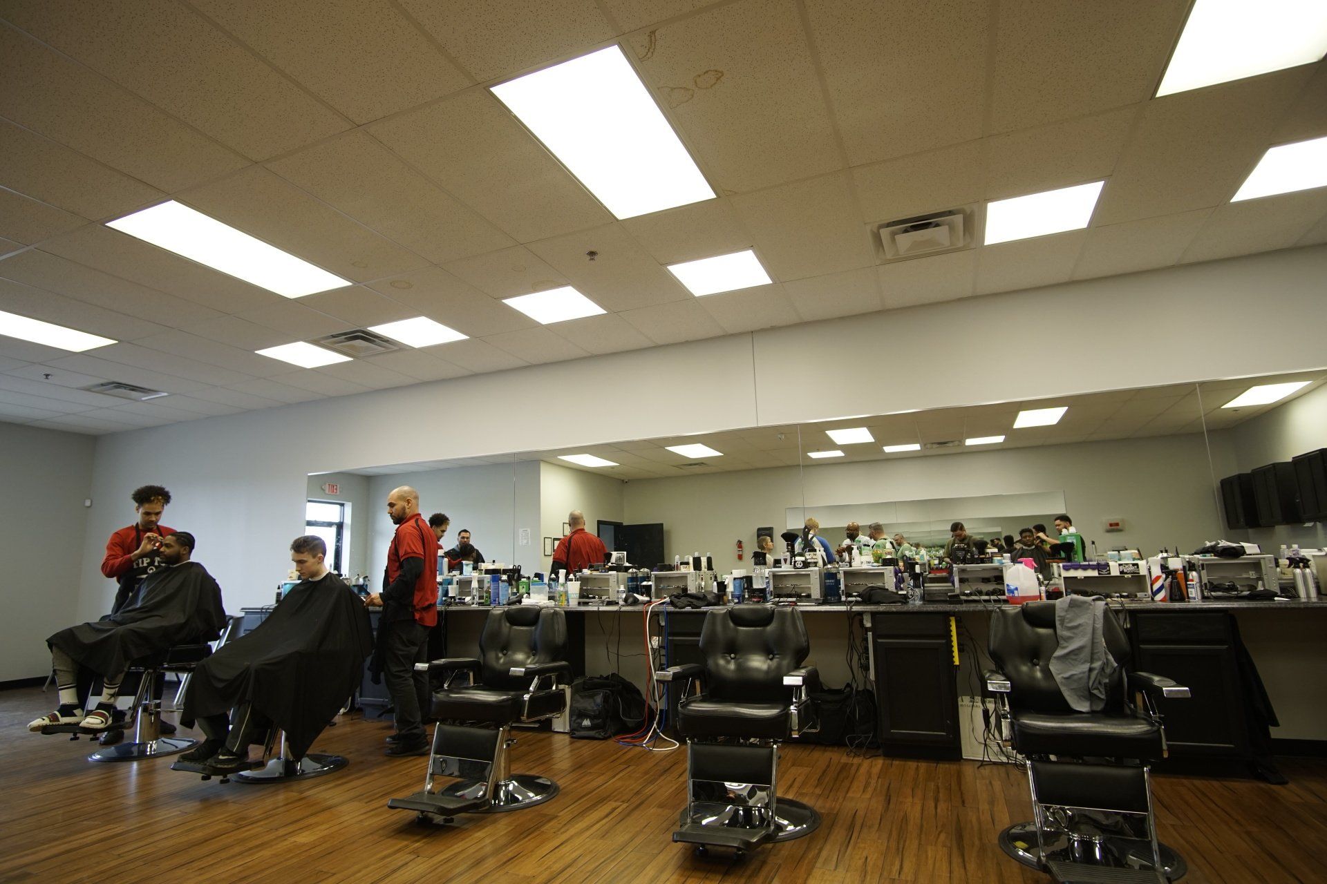 A man is getting his hair cut at a barber shop