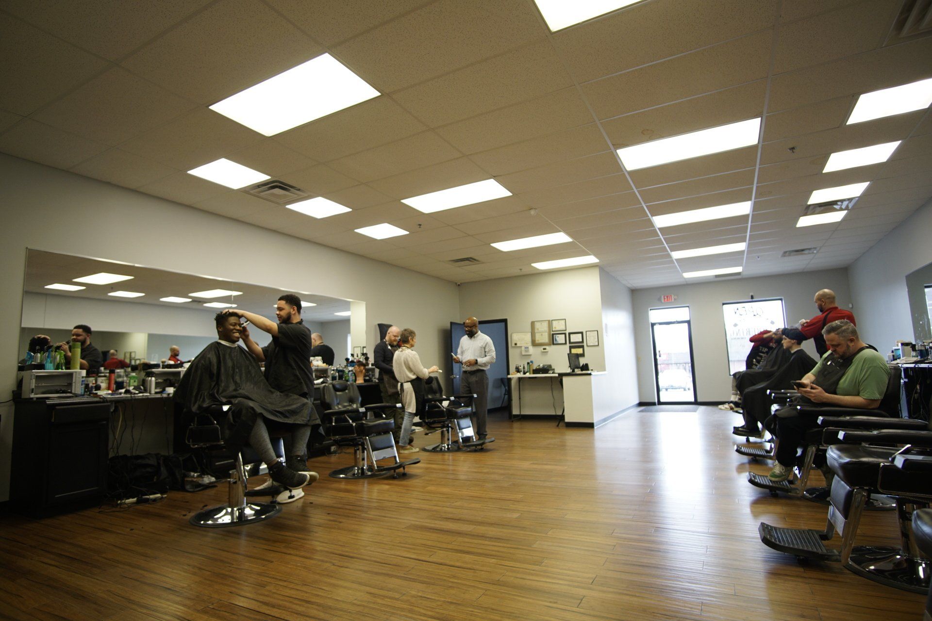 A man is getting his hair cut in a barber shop.