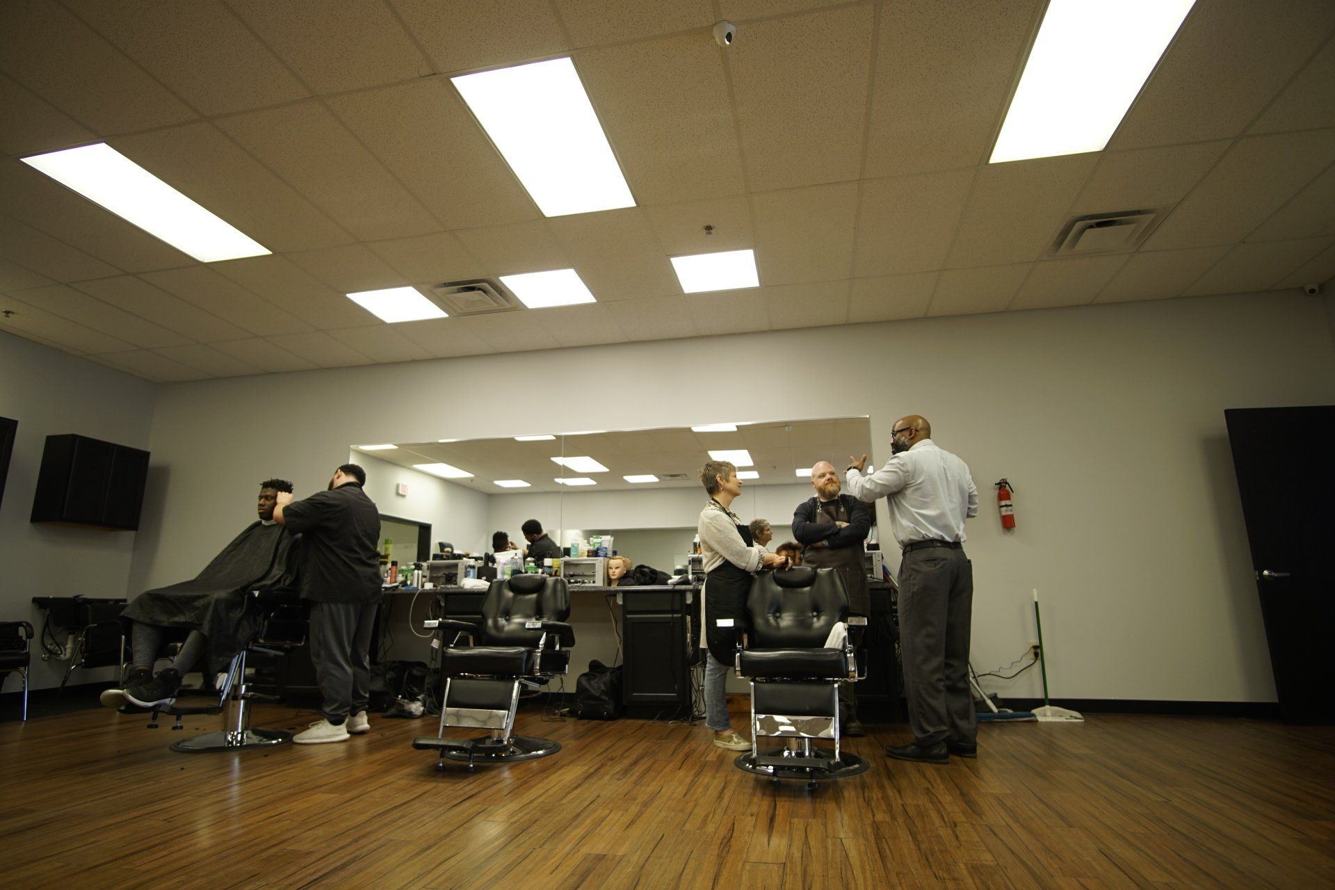 A man is getting his hair cut at a barber shop