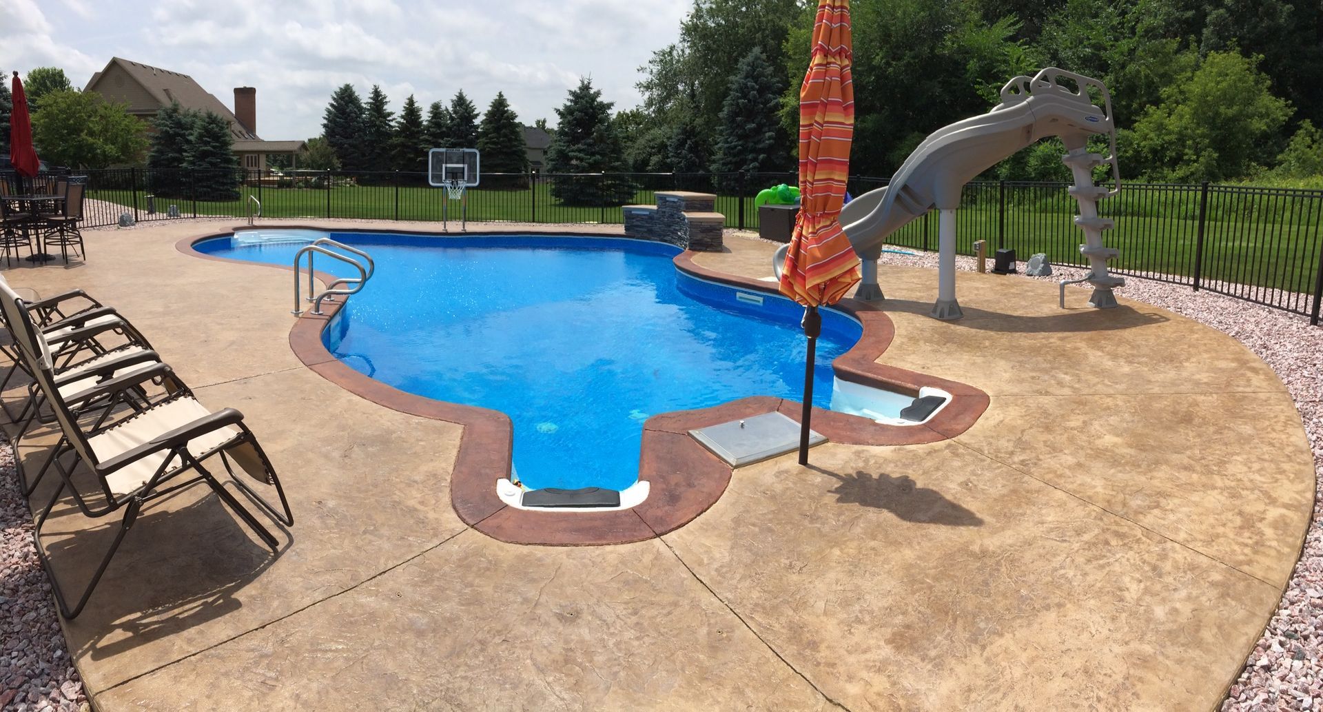 In-ground pool with hydrotherapy and slide