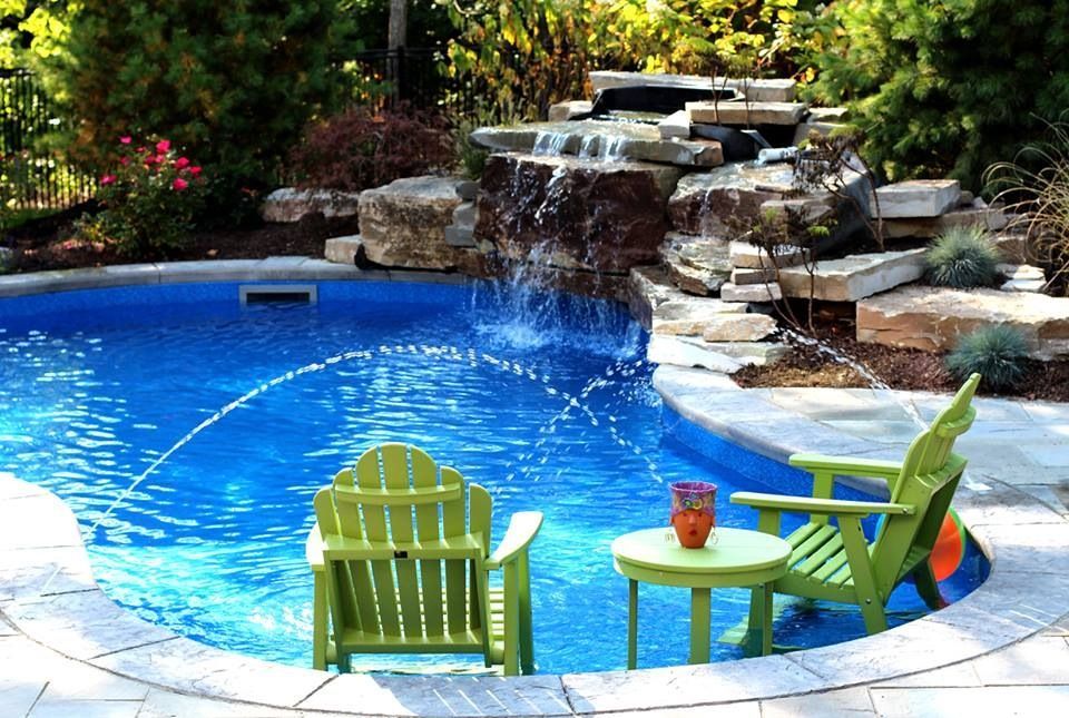 Outdoor In-ground pool with fountains and waterfall