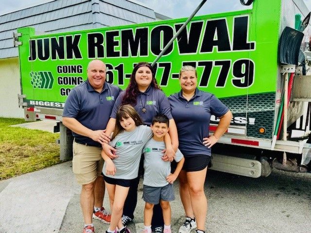 A family standing in front of a junk removal truck