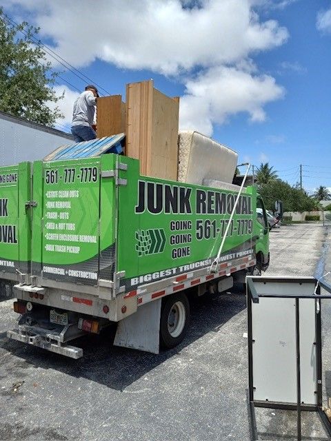 A junk removal truck is parked on the side of the road.