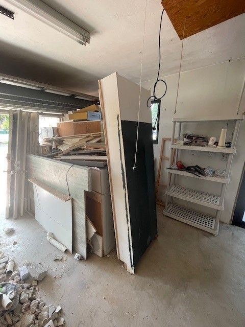 A room with a lot of junk on the floor