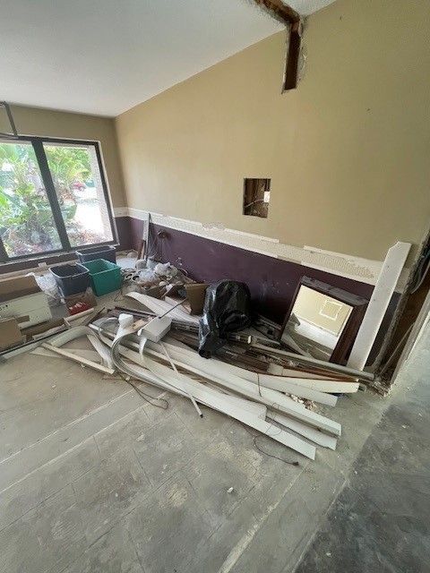 A room under construction with a lot of junk on the floor.