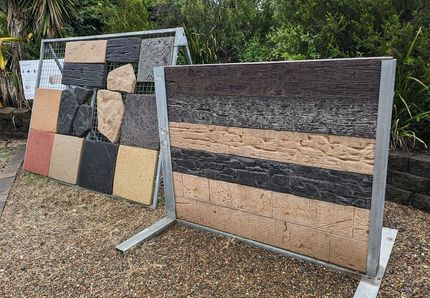 A Man is Standing Next to a Large Brick Wall — Golden City Gympie Brick & Landscape in Gympie, QLD