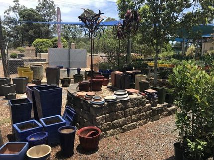 A Bunch of Pots Are Sitting on the Ground in a Garden— Golden City Gympie Brick & Landscape in Gympie, QLD
