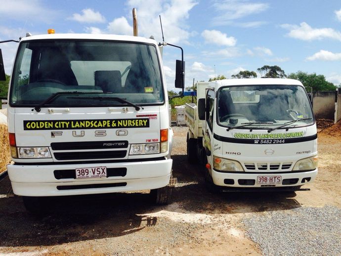 Two Parked White Trucks — Golden City Gympie Brick & Landscape in Gympie, QLD