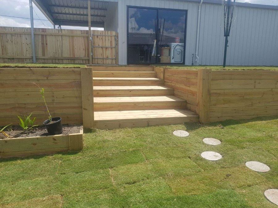 A Wooden Staircase Leading Up to a House in a Backyard — Golden City Gympie Brick & Landscape in Gympie, QLD