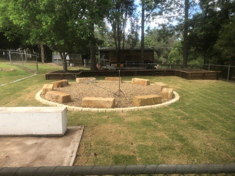 A Circle of Rocks in the Middle of a Lush Green Field — Golden City Gympie Brick & Landscape in Gympie, QLD