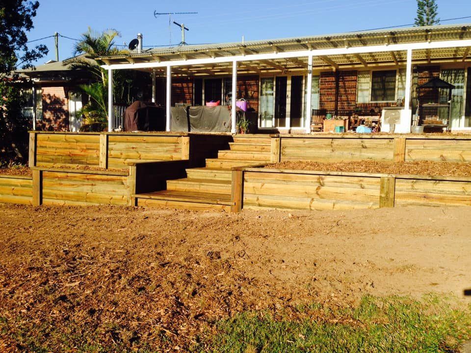 A Lot of Crates Are Sitting on the Ground in a Gravel Area — Golden City Gympie Brick & Landscape in Gympie, QLD
