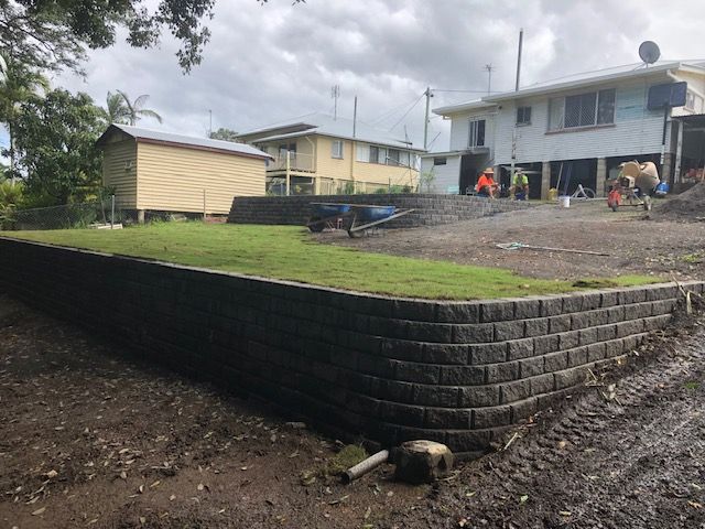 A Brick Wall With Stairs Leading Up to a House — Golden City Gympie Brick & Landscape in Gympie, QLD