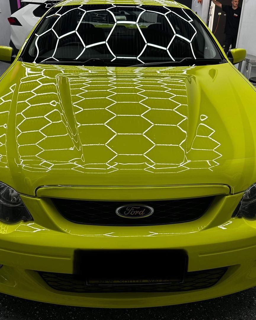 A Yellow Ford Car With a Honeycomb Pattern on the Hood — VIP Car Care Newcastle in Cardiff, NSW