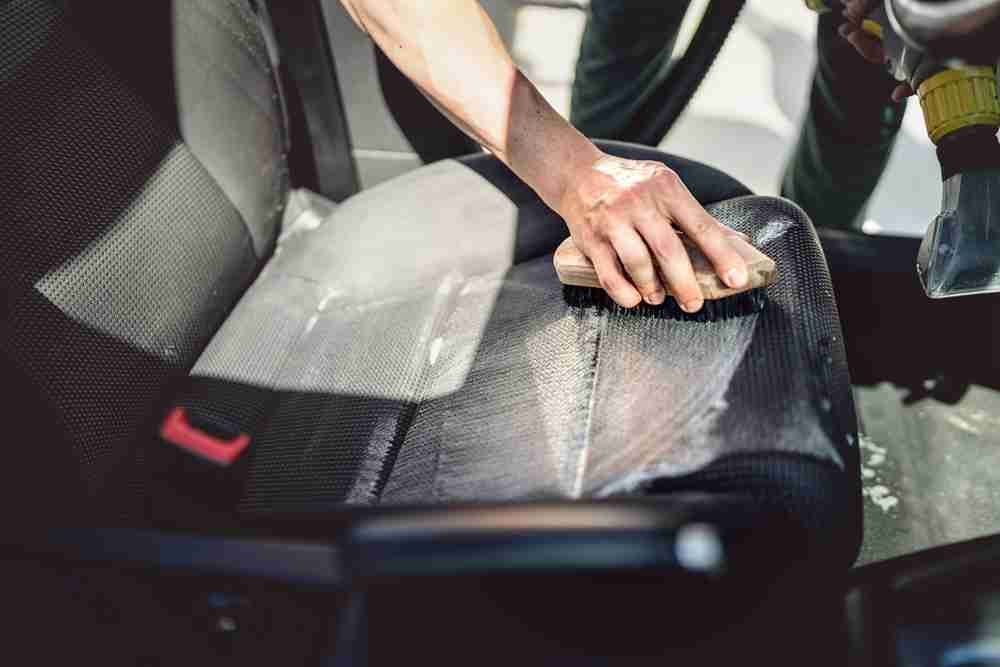 Skilled Persong Cleaning Car Seat with Soap — Car Wash in Cardiff