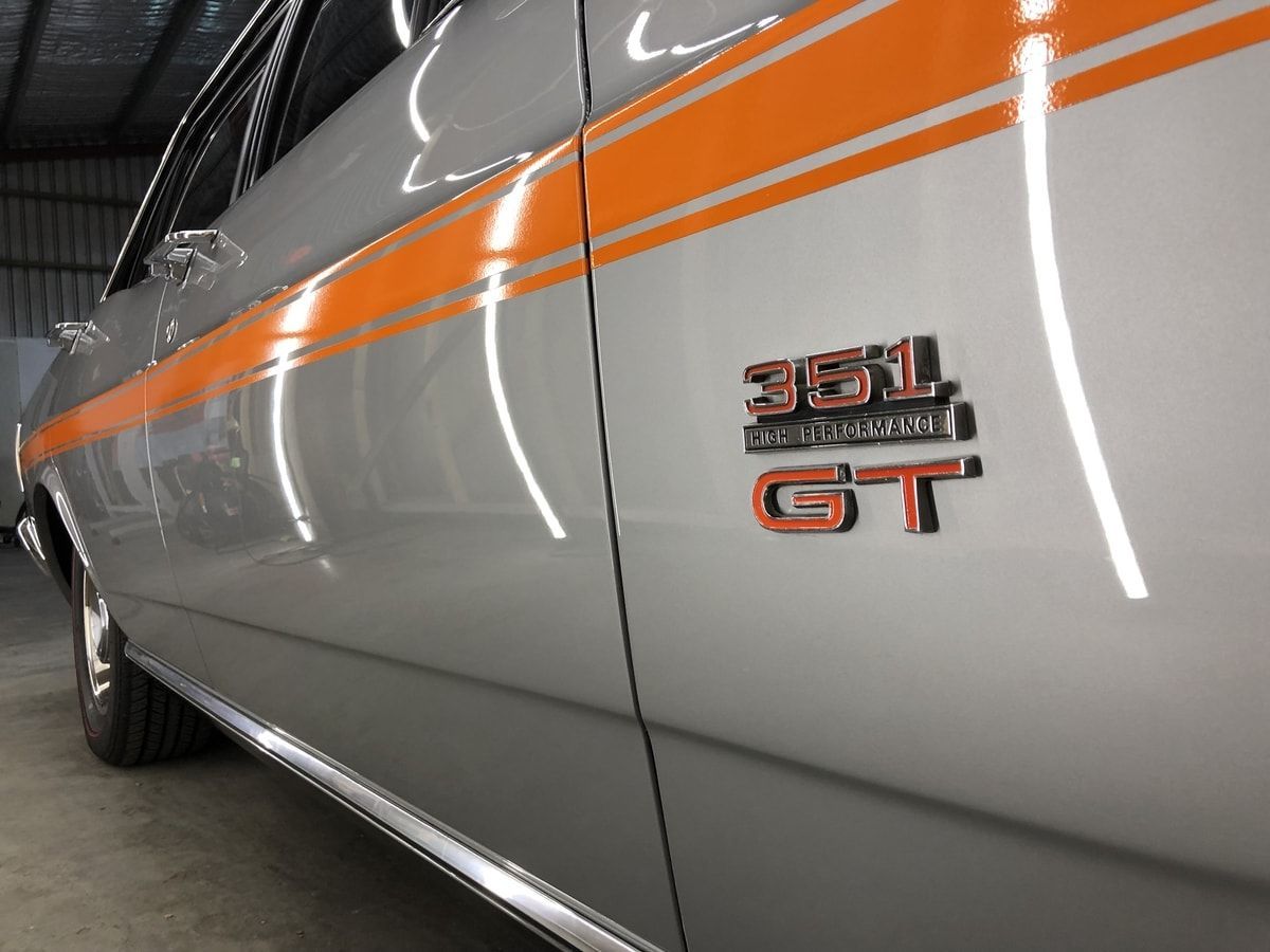 A Silver Car With Orange Stripes and a 351 Gt Emblem — VIP Car Care Newcastle in Newcastle, NSW