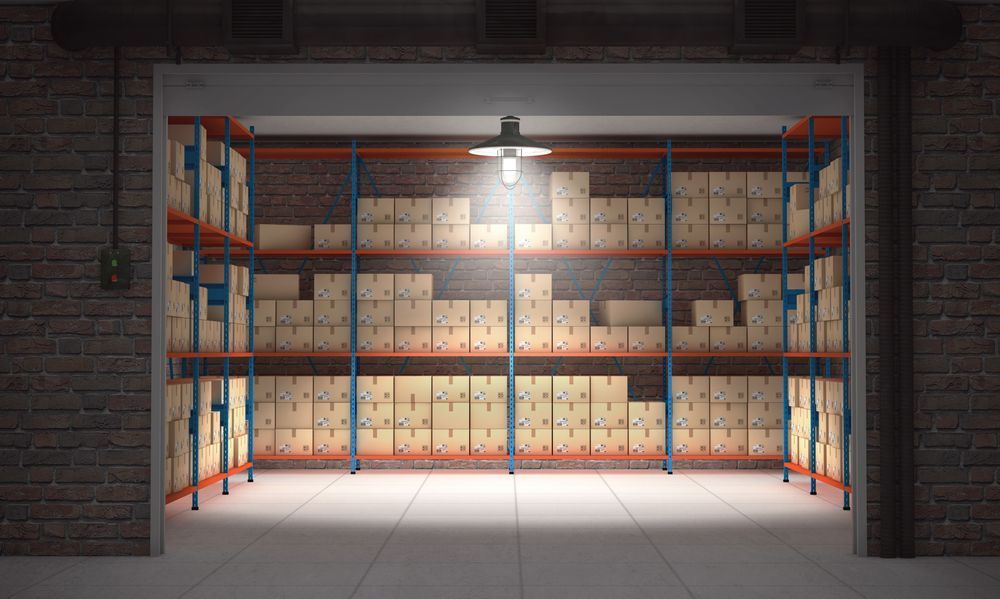A Storage Warehouse With Shelves Filled With Cardboard Boxes — King Street Storage Emerald in Emerald, QLD