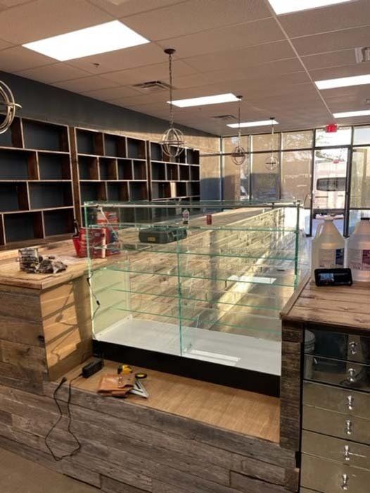 A store with a lot of shelves and a glass display case.