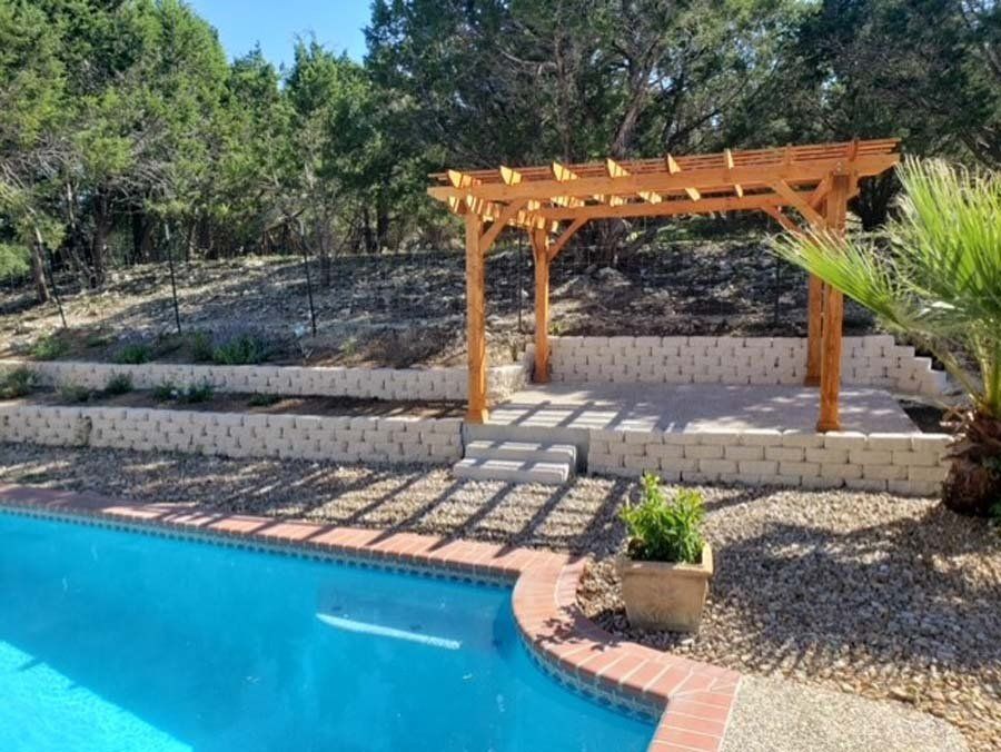 A swimming pool with a wooden pergola in the backyard