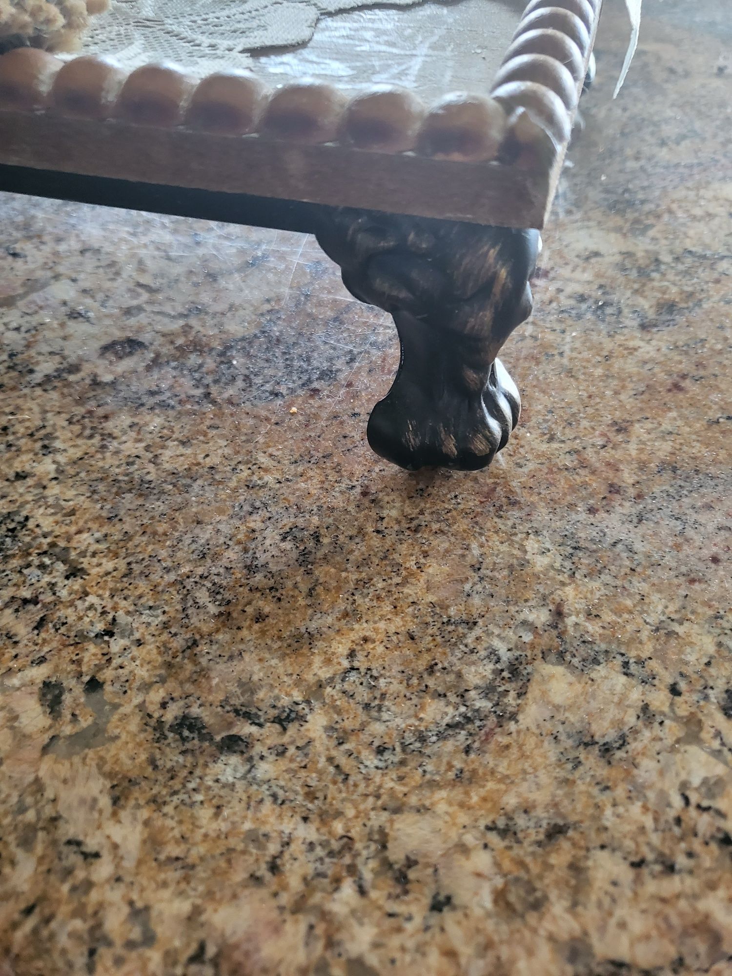 a close up of a claw foot on a table. Interior decorating tip to use risers